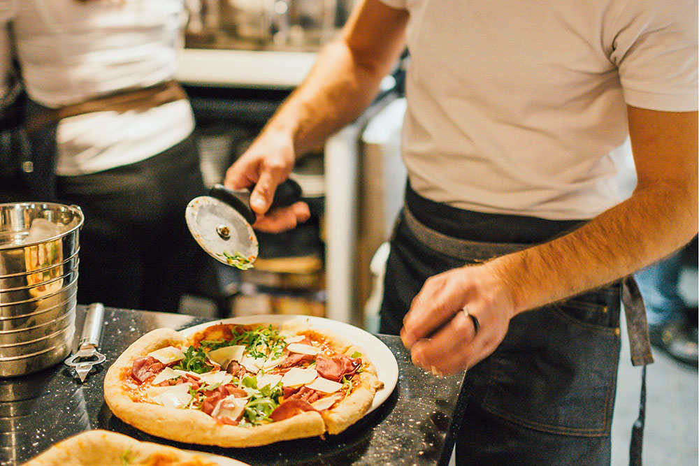 Pizza making team building man